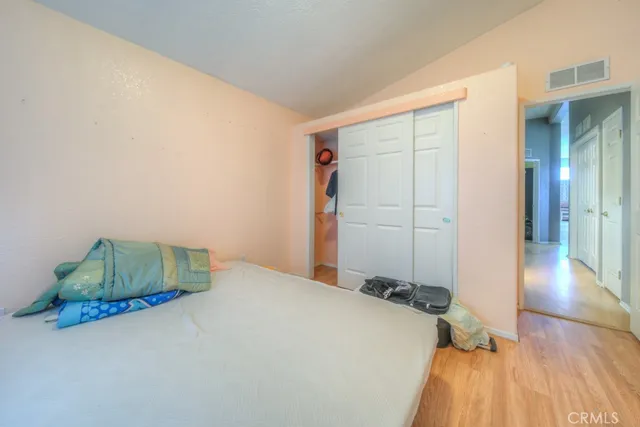 a bathroom with a granite countertop toilet sink and mirror