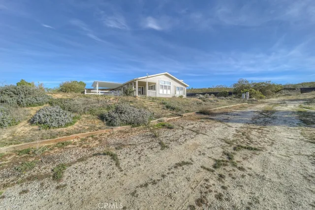 a big house with a big yard and large trees