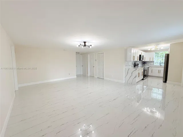 a kitchen with white cabinets stainless steel appliances and sink