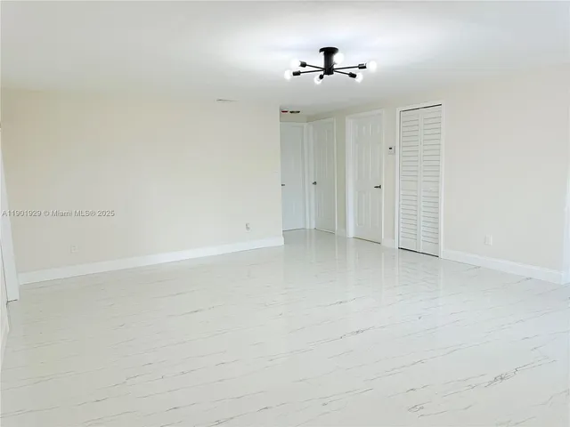 a kitchen with white cabinets sink and stainless steel appliances