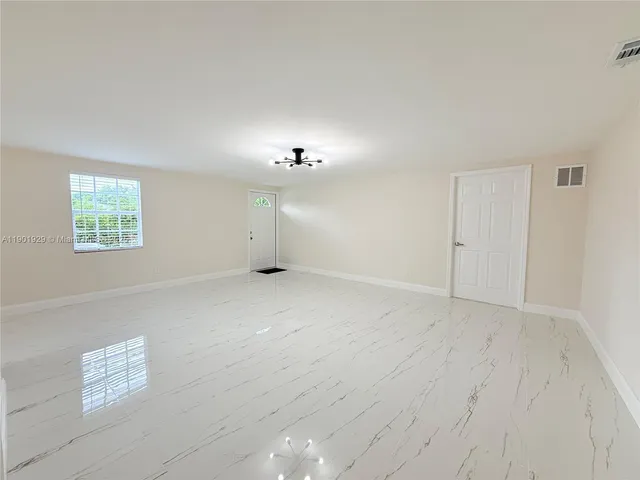 a kitchen with granite countertop a sink and a stove top oven with wooden floor