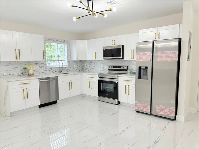 a view of a room with wooden floor and fan