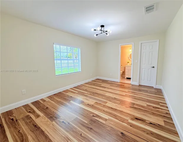 a view of a room with wooden floor
