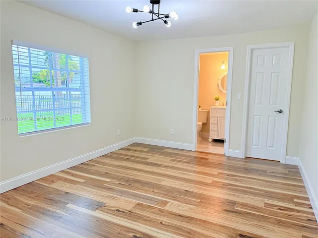 a bathroom with a toilet a sink a vanity and mirror