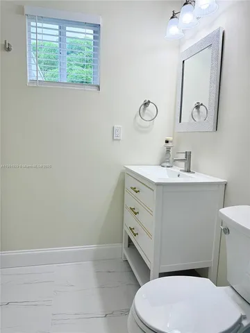 a view of a backyard with plants and palm trees