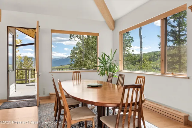a view of a dining room with furniture window and outside view