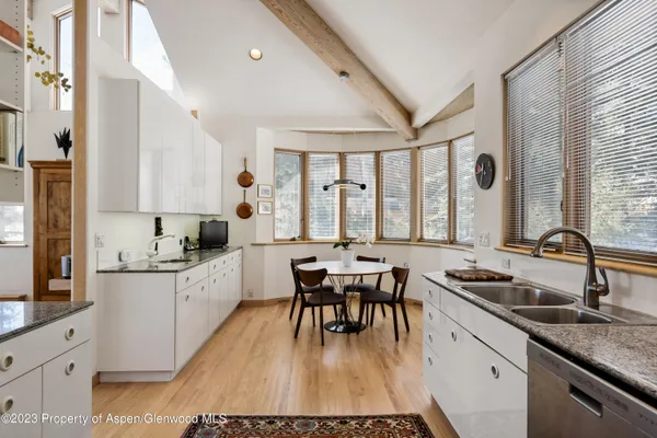 a kitchen with a refrigerator and a sink