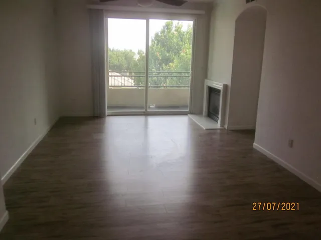 a view of wooden floor and windows in a room