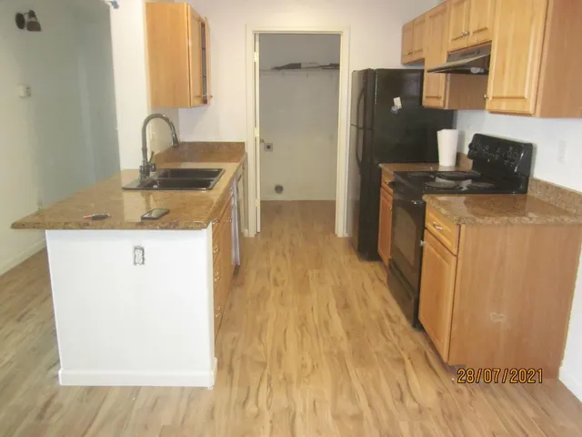 a kitchen with a sink and wooden cabinets