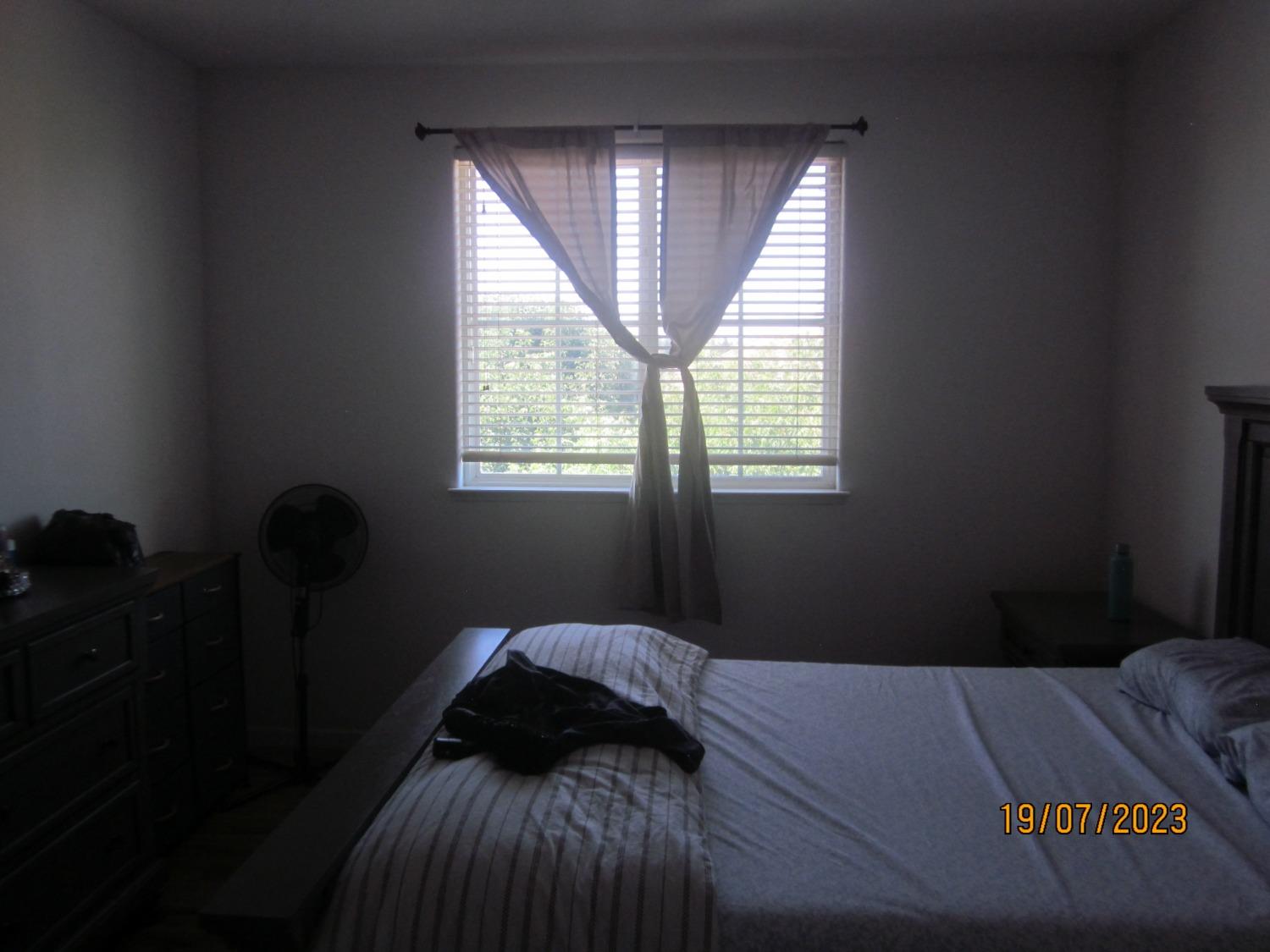 1360 Shady Lane, Unit 733 Turlock, CA 95382 - Photo 18 of 20 a bedroom with a bed and window