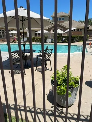 a view of swimming pool with outdoor seating