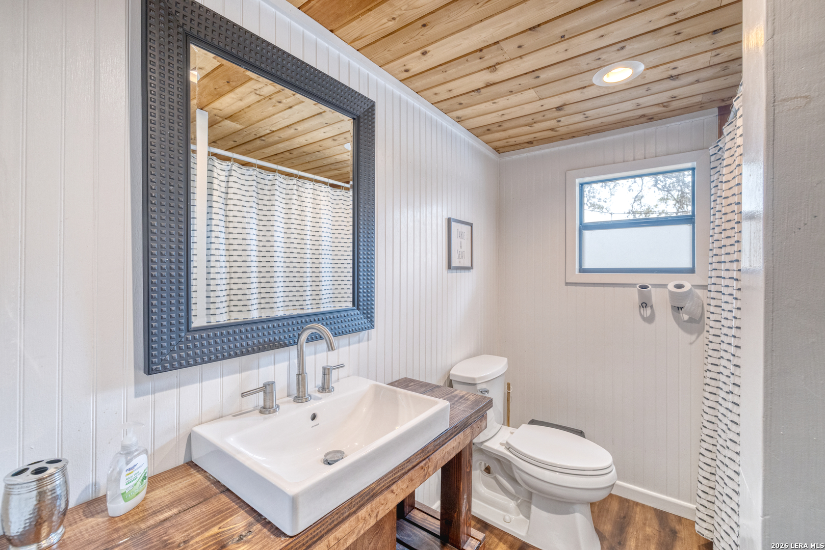 1674 Flat Rock Road Rio Frio, TX 78879 - Photo 18 of 39 a bathroom with a sink a toilet and a mirror