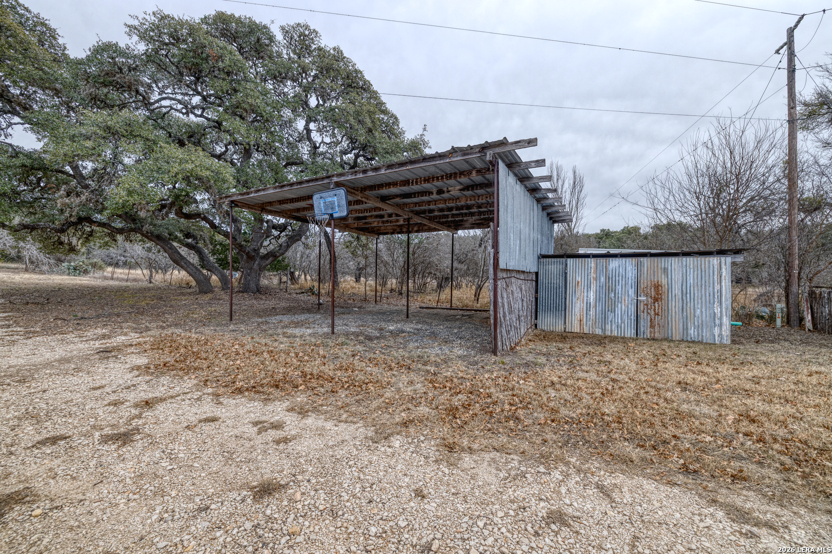 1674 Flat Rock Road Rio Frio, TX 78879 - Photo 10 of 39 a view of backyard with wooden fence and large trees
