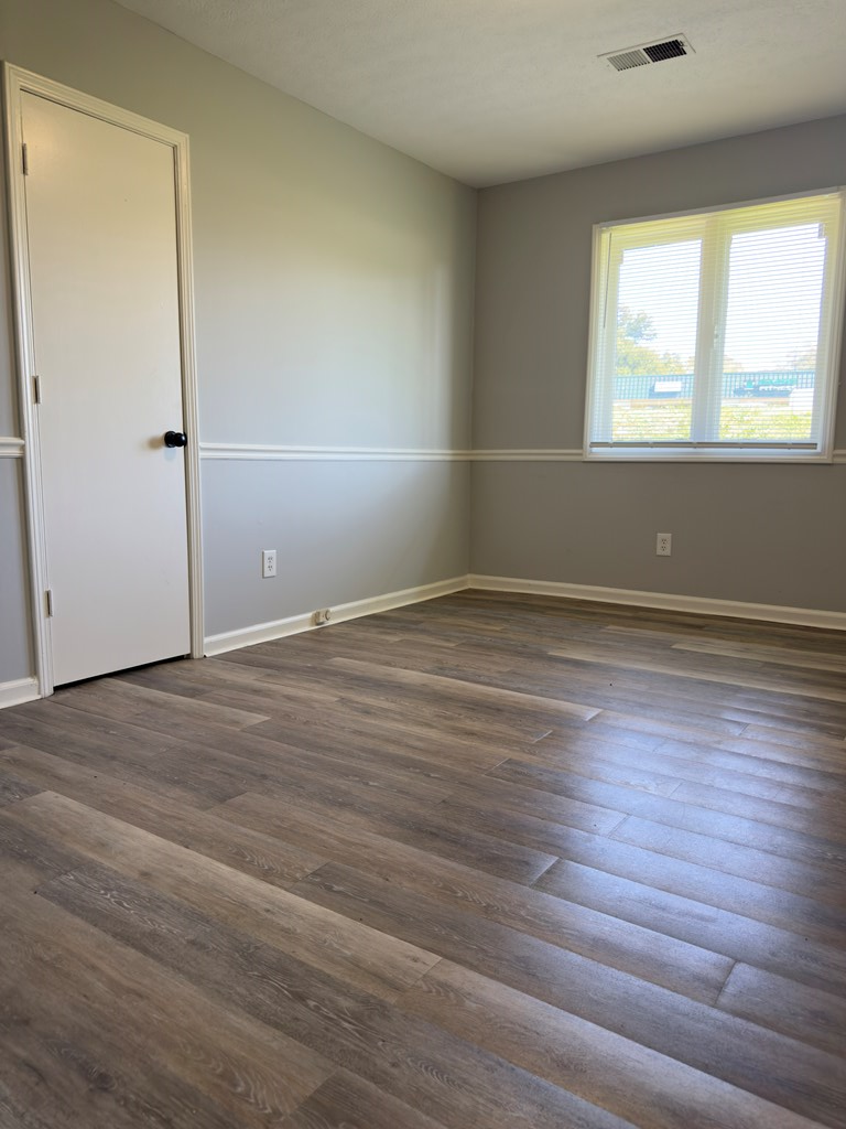 5829 Moon Road Columbus, GA 31909 - Photo 12 of 20 an empty room with wooden floor and windows