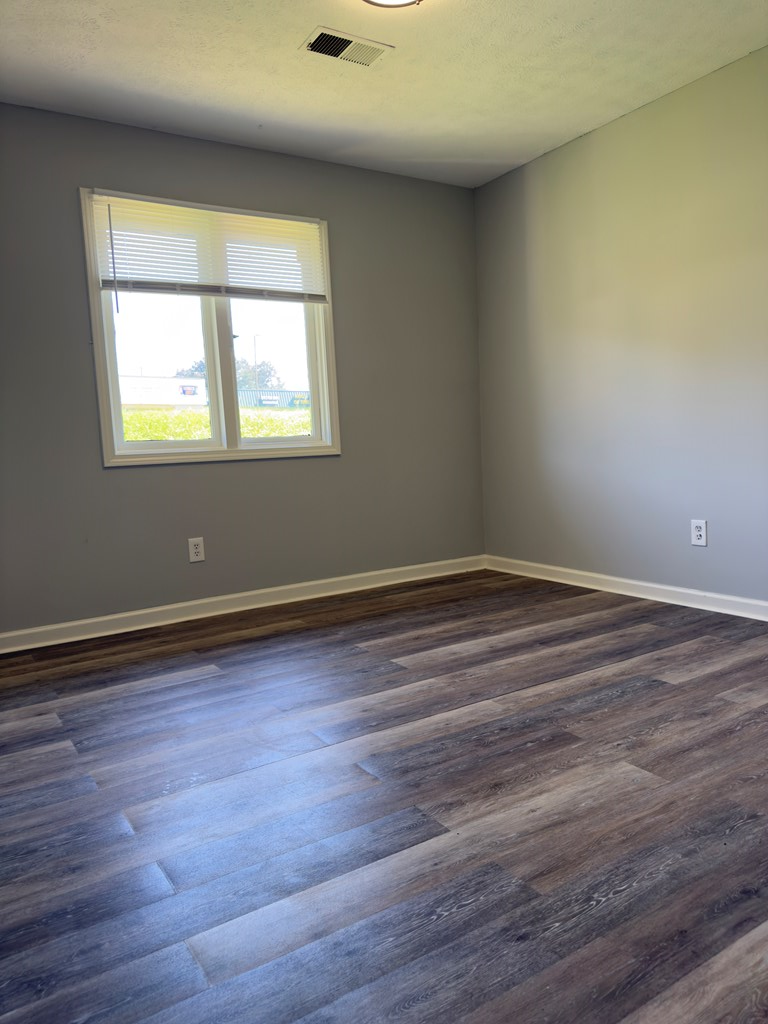 5829 Moon Road Columbus, GA 31909 - Photo 15 of 20 a view of an empty room with wooden floor and a window