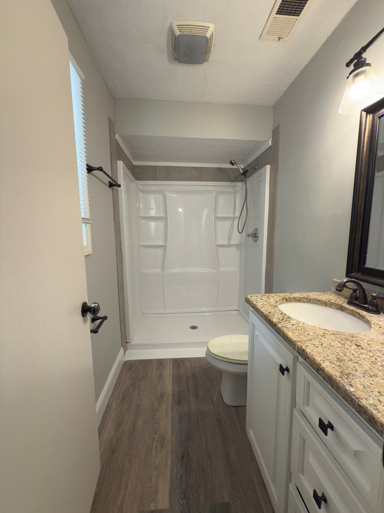 5829 Moon Road Columbus, GA 31909 - Photo 17 of 20 a bathroom with a granite countertop sink toilet and shower