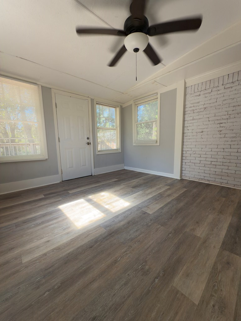 5829 Moon Road Columbus, GA 31909 - Photo 18 of 20 an empty room with wooden floor chandelier fan and windows