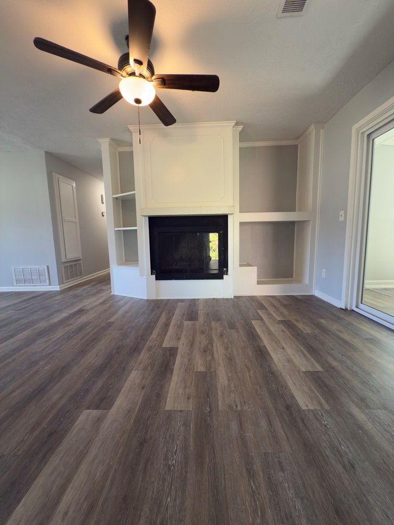 5829 Moon Road Columbus, GA 31909 - Photo 9 of 20 a view of a livingroom with wooden floor a ceiling fan and windows
