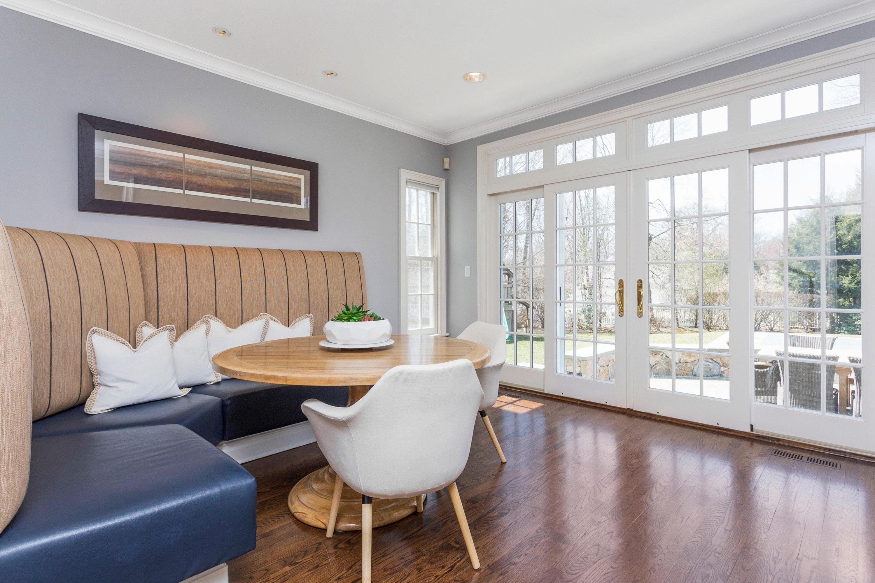 495 Hollow Tree Ridge Road Darien, CT 06820 - Photo 15 of 33 a dining room with furniture a chandelier and wooden floor