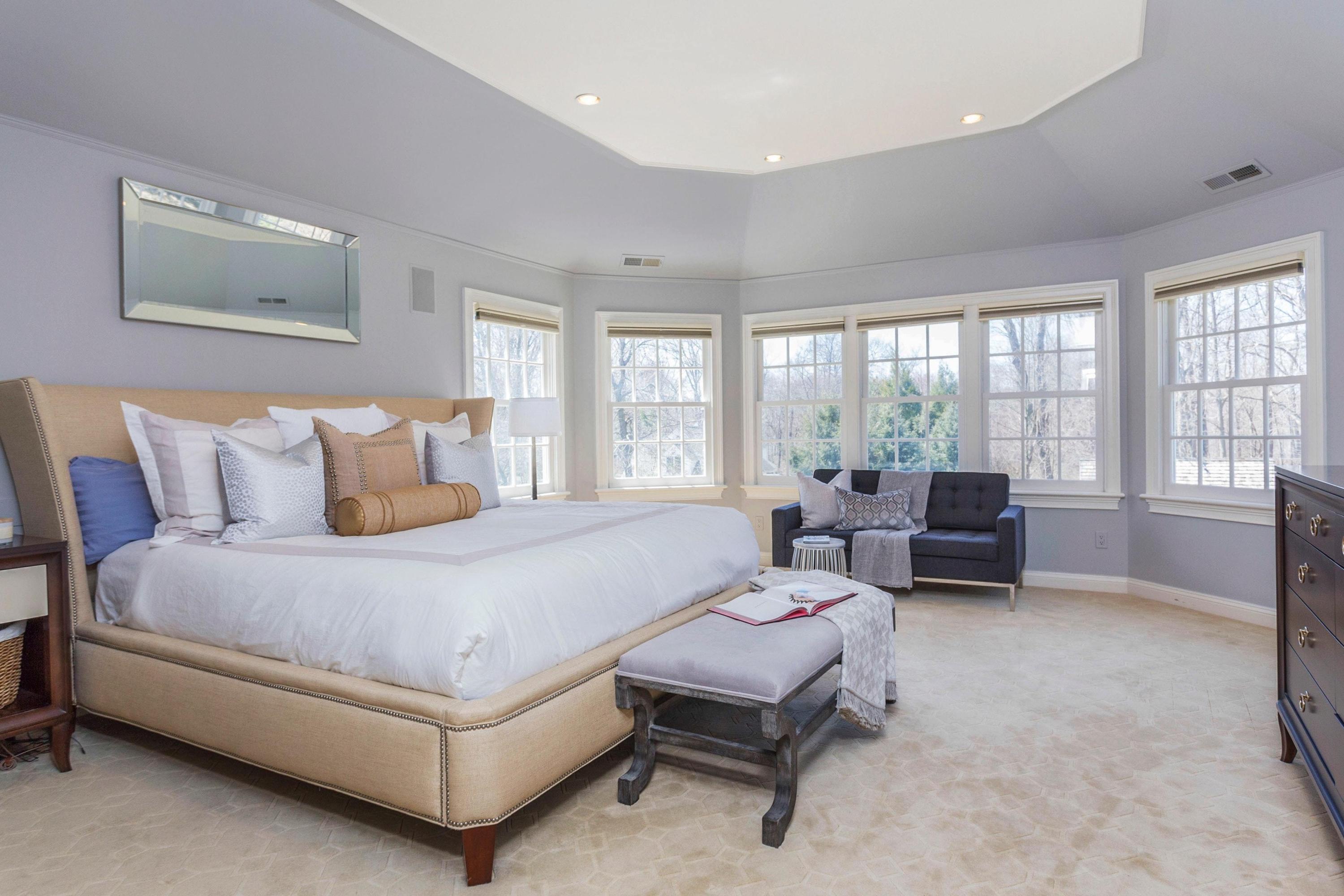 495 Hollow Tree Ridge Road Darien, CT 06820 - Photo 18 of 33 a spacious bedroom with a bed and a couch