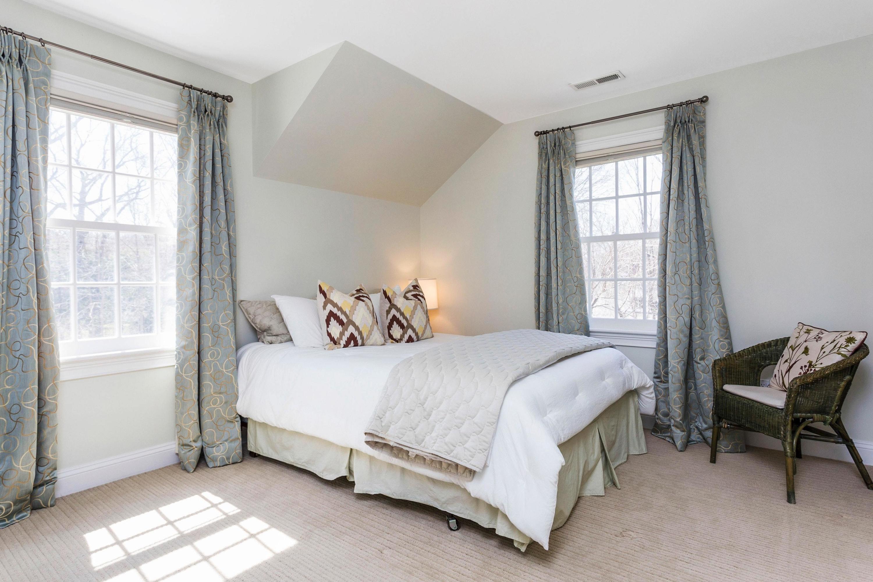 495 Hollow Tree Ridge Road Darien, CT 06820 - Photo 23 of 33 a bed sitting in a bedroom next to a window