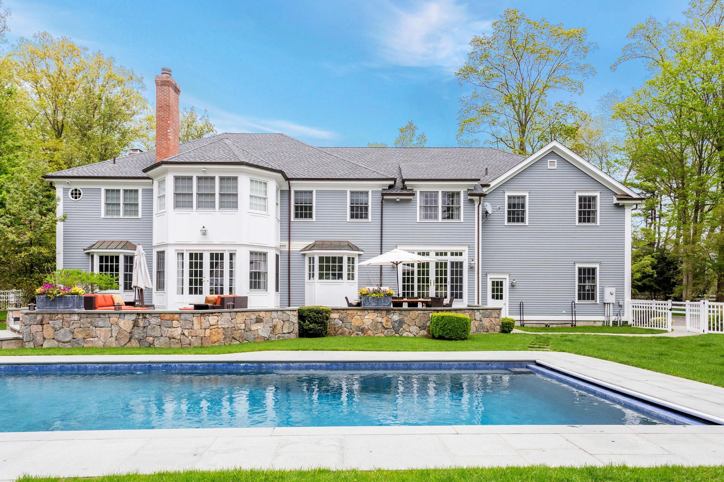 495 Hollow Tree Ridge Road Darien, CT 06820 - Photo 26 of 33 a front view of a house with a swimming pool