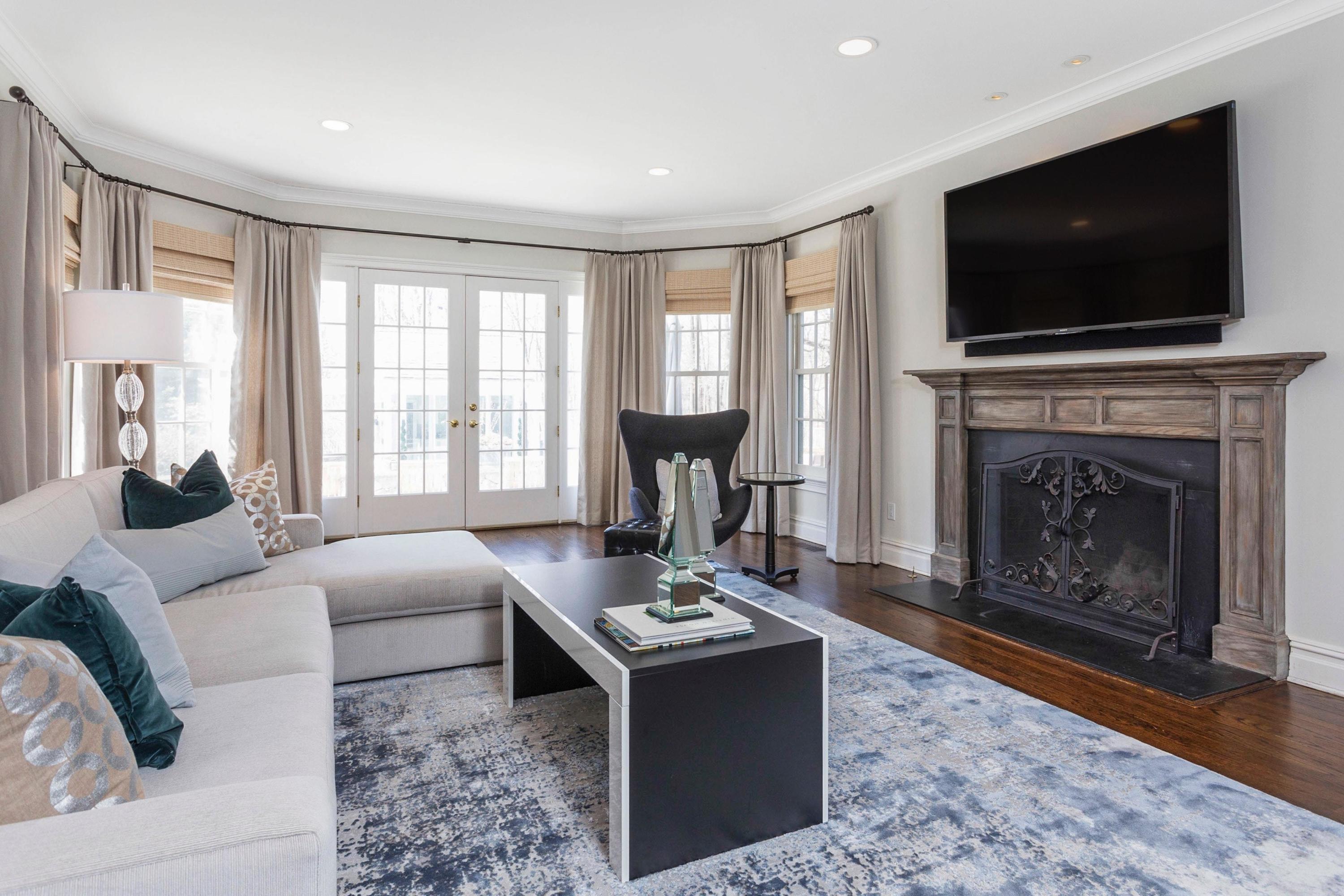 495 Hollow Tree Ridge Road Darien, CT 06820 - Photo 10 of 33 a living room with fireplace furniture and a flat screen tv