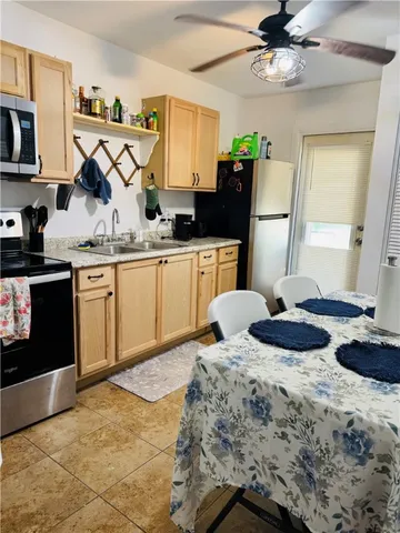 a kitchen with a sink appliances and cabinets