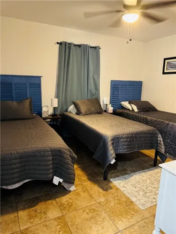 a bedroom with a bed dresser and a window