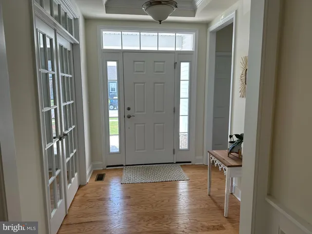 a kitchen with stainless steel appliances granite countertop a sink stove oven and white cabinets with wooden floor