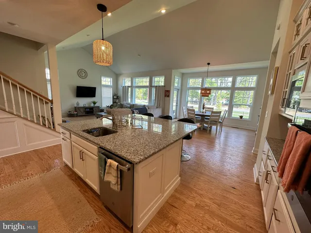 a kitchen with stainless steel appliances granite countertop a stove and a wooden floors