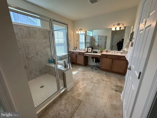 a bedroom with a bed flat screen tv and a window