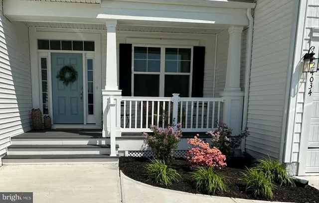 a front view of a house with a flower garden