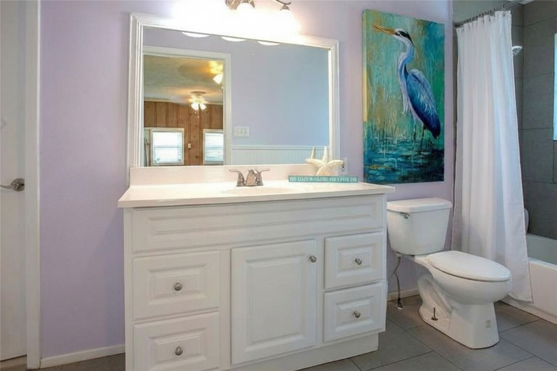 959 South East Road Crystal Beach, TX 77650 - Photo 19 of 20 a bathroom with a sink a toilet and a mirror