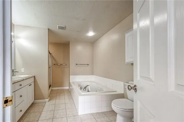 a spacious bathroom with a shower sink and mirror
