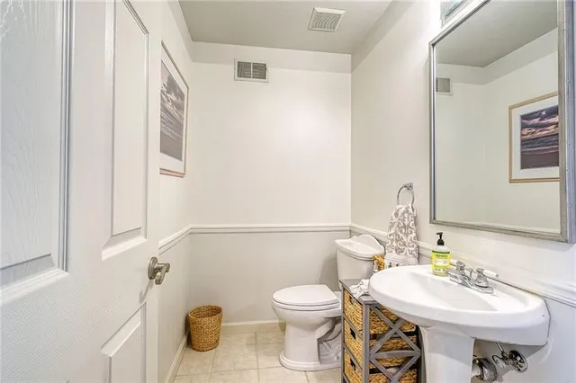 a bathroom with a sink toilet and mirror