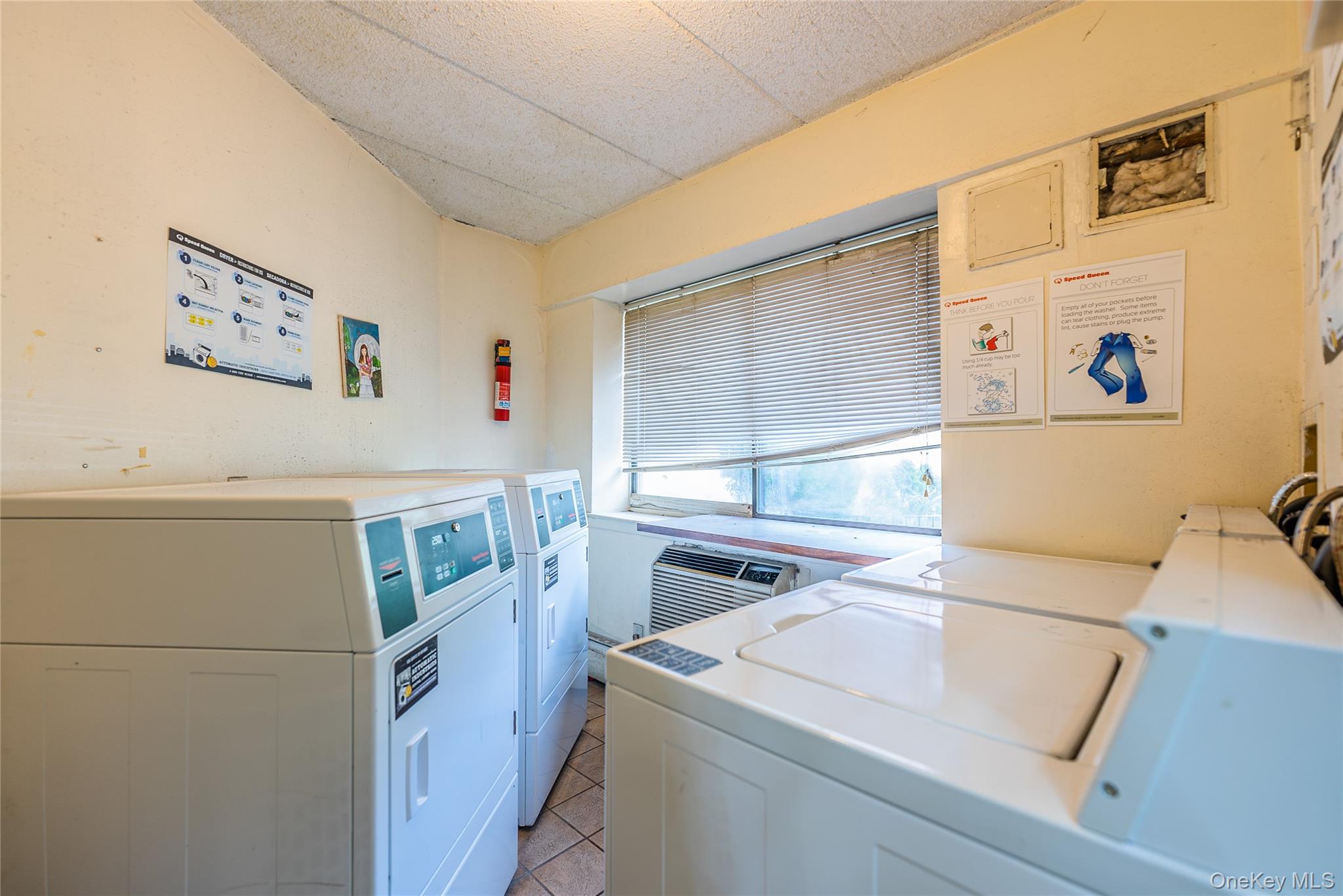 54-09 108th Street, Unit 3A Queens, NY 11368 - Photo 2 of 4 a utility room with dryer and washer