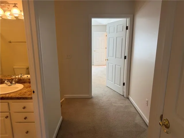 a view of a bathroom from a hallway
