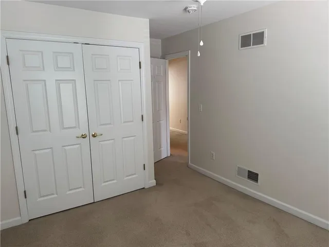 an empty room with closet area