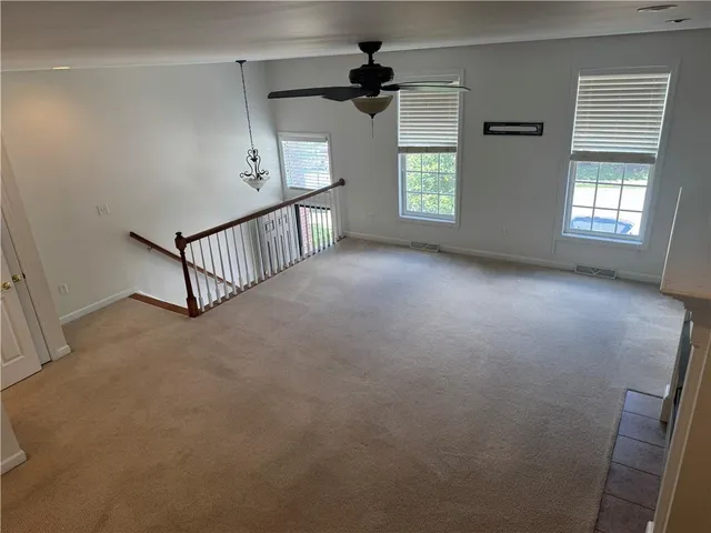 wooden floor in a hall with an entryway and a window