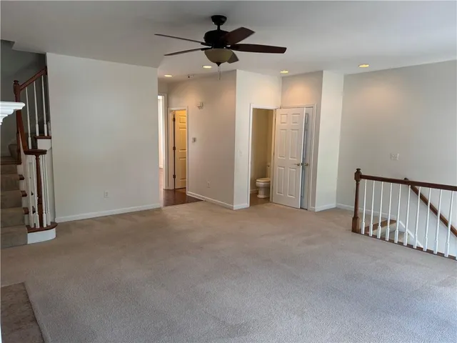 a view of a hallway with a chandelier fan