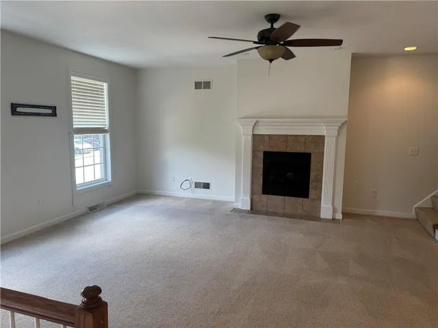 a view of empty room with fan and window