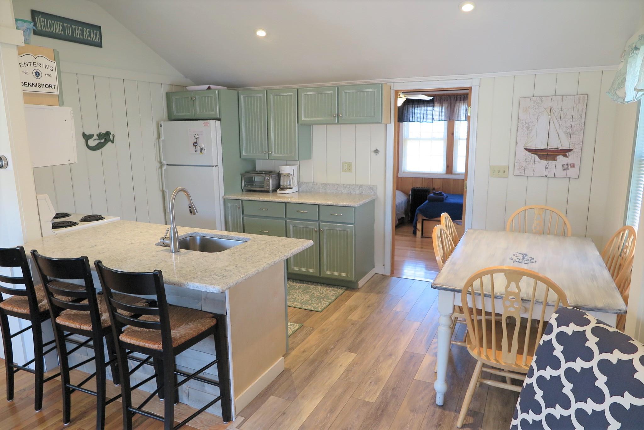 25 Susan Ruth Road Dennis Port, MA 02639 - Photo 8 of 40 a view of a dining room with furniture and wooden floor