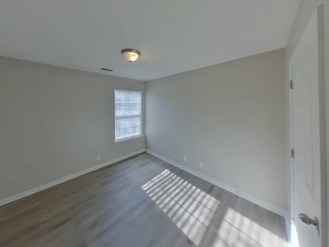 a view of an empty room and a window