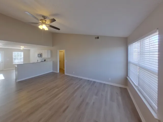 wooden floor in an empty room with a window