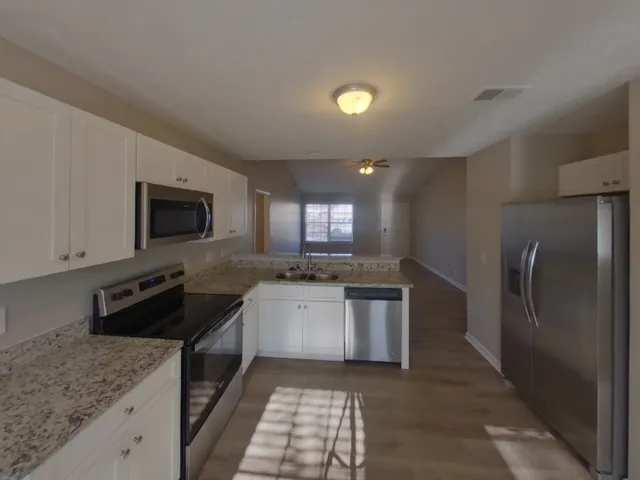 a kitchen with a sink stove and refrigerator