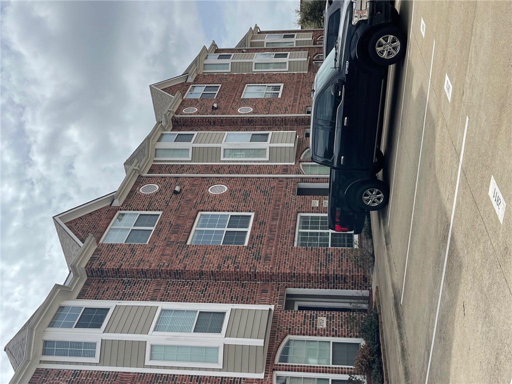 1198 Jones-Butler Road, Unit 2706 College Station, TX 77840 - Photo 10 of 17 a car parked in front of a brick building