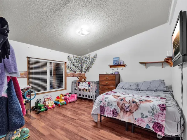 a bedroom with bed and a window