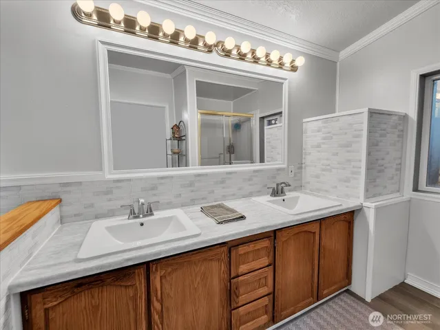 a bathroom with a sink double vanity and a mirror