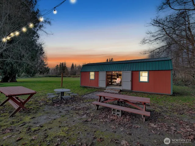 a backyard of a house with table and chairs
